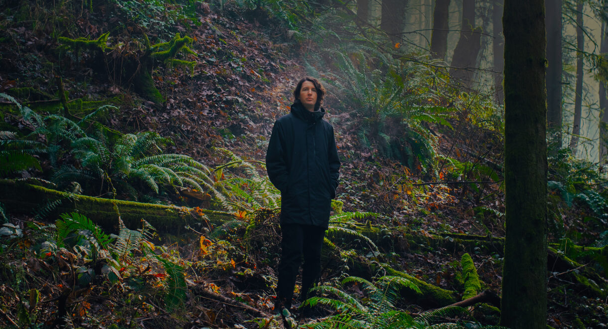 Spencer Doran standing in Oregon woods.